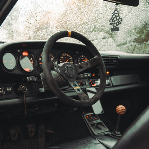 porsche 964 interior with wooden shifter and momo steering wheel